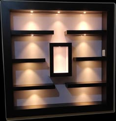 an illuminated display case with shelves and lights