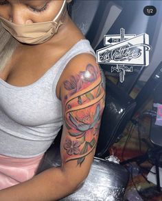 a woman with a mask on her face and arm covered by a sleeve tattoo design