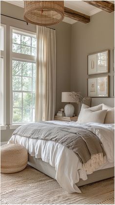 a large bed sitting under a window in a bedroom