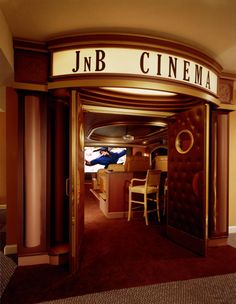 the entrance to j n b cinema with chairs and tables in it's doorway