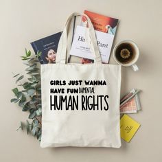 a tote bag with the words girls just wanna have fun important human rights on it