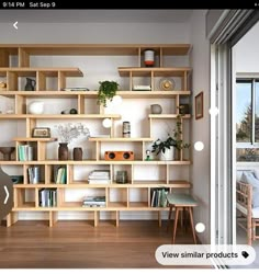 a living room filled with lots of wooden shelves