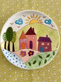 a small plate with houses painted on it