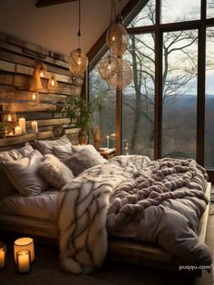 a bedroom with a large bed covered in blankets and pillows next to a tall window