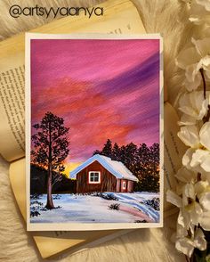 a painting of a red barn in the snow with white flowers and an open book