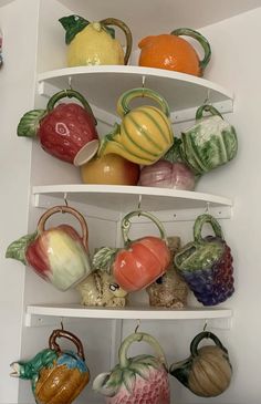 a shelf filled with lots of different colored vases