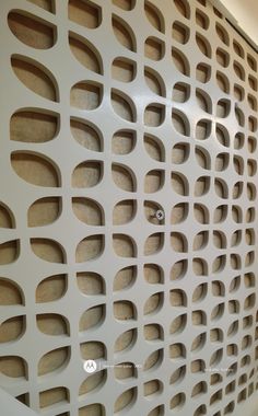 a white wall with holes and circles on it