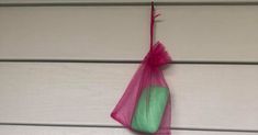 a pink and green bag hanging on the side of a house