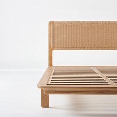 a wooden bed frame sitting on top of a white floor