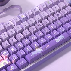 a purple computer keyboard sitting on top of a desk