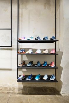 there are many pairs of shoes on the shelves