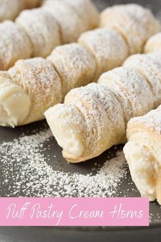 puff pastry cream horns on a baking sheet with powdered sugar and pink text overlay