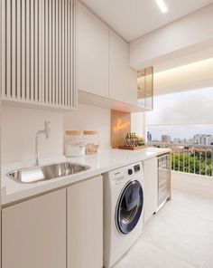 a washer and dryer in a small room with an open window overlooking the city