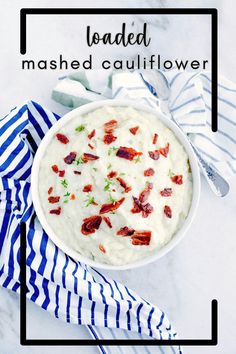 mashed cauliflower with bacon in a white bowl on a blue and white striped napkin