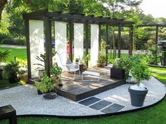 an outdoor area with chairs and plants in it