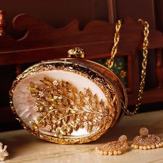 Luxury Mother of Pearl Shell Minaudiere Clutch Purse Elevate your evening look with our stunning Mother of Pearl Shell Minaudiere Clutch--a luxurious fan-shaped evening bag perfect for weddings, engagements, Diwali, Christmas, baby shower and other special occasion. Crafted from high-quality mother of pearl sourced from the Indian Ocean, this unique clutch is both a fashion statement and a timeless accessory. Elevate your style with this stunning ocean-inspired mini seashell handbag, meticulousl Bridesmaid Purses, Bridal Clutches, Pearl Clutch, Clutch Bag Wedding, Party Clutch, Unique Purses, Designer Clutch, Mooncake, Luxury Gift Box