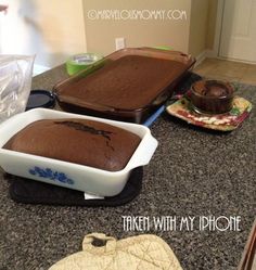 two pans filled with cake sitting on top of a counter