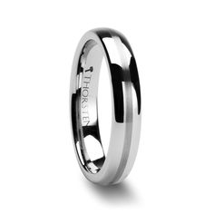 a men's wedding ring with black and white inlays on the side