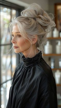 into effortless chic with a high messy bun – a trendy and versatile hairstyle perfect for older women seeking both style and convenience. This elevated yet relaxed look adds a touch of casual elegance to any outfit, perfect for busy days or special occasions. Click to explore more age-defying hairstyles and follow us for daily inspiration! #HighMessyBun #EffortlessChic #HairstylesForOlderWomen #CasualElegance #TrendyHair Older Punk Women, Updo Hairstyles For Long Hair, Hairstyles For Older Women, Age Defying, Women Over 50