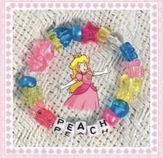 a bracelet made out of gummy bears with the word peach on it and an image of princess peach