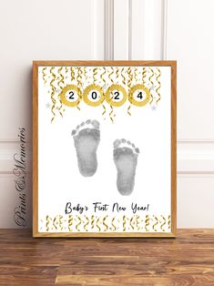 a baby's first new year card with footprints