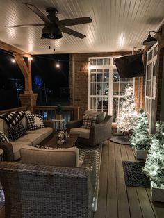 a living room filled with furniture and a christmas tree on top of a wooden floor