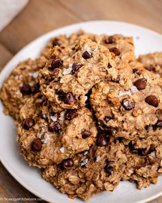 a white plate topped with cookies and raisins on top of a wooden table