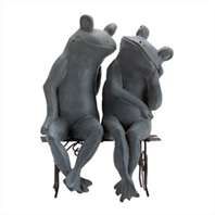 two frogs sitting next to each other on a chair