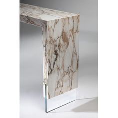 a white marble table with a glass base