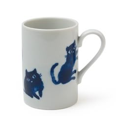 a blue and white coffee cup with cats on it