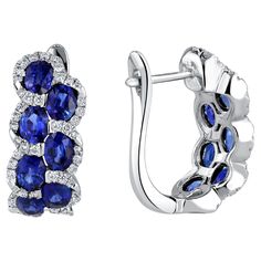 Indulge in the enchanting allure of these lever-back earrings, each adorned with seven mesmerizing oval-cut sapphires per earring, totaling an impressive 2.88 carats. The sapphires, reminiscent of the deep blue skies, are delicately nestled among a trail of brilliant round white diamonds, adding a touch of sophistication and glamour. The total diamond weight of 0.36 carats enhances the overall sparkle, creating a harmonious balance of color and brilliance. Seven oval-cut sapphires per earring, t Luxury Birthstone Earrings For Engagement, Luxury Diamond Accented Earrings For May Birthstone, Luxury Diamond Earrings With Gemstone Accents As Gift, Luxury Festive Earrings With Stone Setting, Luxury Jewelry With Matching Earrings For May Birthstone, Luxury Sapphire Diamond Earrings For Formal Occasions, Luxury Engagement Birthstone Earrings, Luxury Gemstone Accented Earrings For Anniversary, Luxury Traditional Diamond Earrings With Gemstones