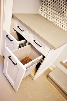 an open cabinet with two bins on the bottom and one in the middle filled with food