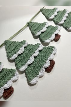 crocheted christmas tree decorations hanging on a string