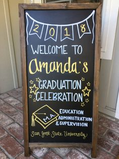 a chalkboard sign with graduation decorations on it that reads welcome to canada's graduation celebration