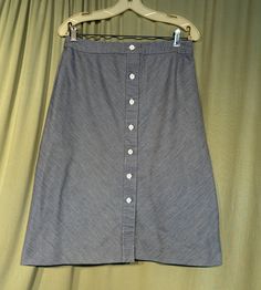 "This is a cute vintage A line skirt, from the 70s. Labeled Schrader Sport & tagged a size 16. Waist measures 30\", please see measurements.  Made of cotton denim in a blue & white ticking stripe. It is an A-line skirt, that reaches below the knee. Buttons all the way down the front with white plastic buttons. The skirt is in very good condition. No soil or stains.  No damage. No fading. Sweet! Measurements were taken with the garment lying flat. If you have never worn vintage before, please mea Retro Bottoms With Button Closure, Retro Button-up Bottoms For Spring, Vintage Skirt Bottoms With Button Closure, Retro Cotton Skirt With Buttons, Vintage Skirt With Button Closure, Vintage Knee-length Cotton Bottoms, Vintage Knee-length Bottoms With Buttons, Vintage Buttoned Denim Skirt For Spring, Vintage Skirt Bottoms With Buttons