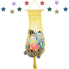 a toy hammock with stuffed animals in it and stars hanging from the ceiling