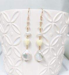 "Neutral and dainty Hawaiian style earrings featuring fresh water pearls , Ethiopian opal and pikake beads. Fresh water pearls are 12-14mm in size. Resin pikake beads are approximately 7-8 mm. Earrings length is approximately 2\" not including ear wires. Hand shaped 14k gold filled French ear wires. PLEASE NOTE: As you can see in the photos there are naturally occurring blemishes that give these pearls characters. These are stock photos so pearls are vary in shape and color." White Pearl Charm Earrings, White Dainty Jewelry With Dangling Beads, Delicate White Jewelry With Dangling Beads, Dainty White Opal Earrings, White Briolette Pearl Drop Earrings, White Opal Drop Earrings, White Pearl Earrings With Dangling Beads As Gift, Delicate White Briolette Earrings, Ethiopian Opal Earrings