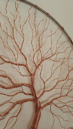 a wire tree is hanging on the wall