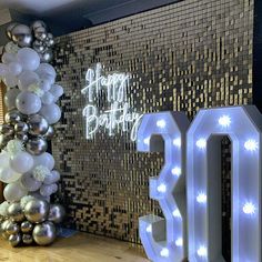 a large balloon arch with the number 30 on it in front of a birthday backdrop