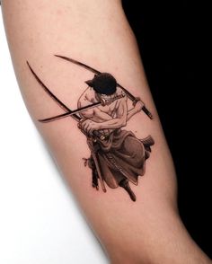 a person with a tattoo on their arm is holding two swords in the other hand