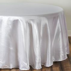 a white table cloth on top of a wooden floor