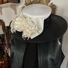 Vintage Wide Brim Black & White Hat ~ Perfect For The Derby! Made In Taiwan ~ R.O.C. A Wide Pleated Black Satin Ribbon Surrounds The Crown And Is Finished In A Rich White Satiny Bow Resting On The Brim With A Center Rosette That’s Flanked With Flowing White Silk Lily-Of-The-Valley Sprigs. Inside Was Lined In A White Grosgrain Ribbon But The Previous Owner Chose To Cut It Out So That Is Not A Separation Of Any Kind ~ It’s The Edges Of The Cut Off White Ribbon Against The Black. Inside Circumference Measures 21” - Crown Height Is 4-1/2”; Brim Is 4”. In Excellent Preowned Vintage Condition. Smoke-Free Home. Elegant Boater Hat With Visor For Spring, Elegant Spring Boater Hat With Visor, Elegant Visor Hat For Spring, Elegant Adjustable Visor Hat, Elegant Spring Visor Hat, White Fitted Top Hat With Flat Brim, Chic White Adjustable Top Hat, White Boater Hat For Evening, Elegant Black Visor Hat