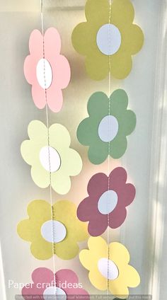 some paper flowers hanging from the ceiling