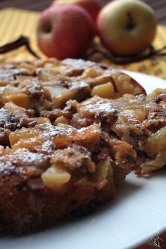 a close up of a plate of food with apples in the background