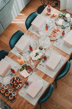 a table set with plates, cups and desserts is shown in this aerial view