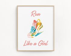 a framed poster with the words run like a girl in front of a pair of sneakers