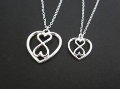 This beautiful sterling silver double heart pendant necklace makes a great gift for everyone. The matching large heart pendant necklace is also available. You can purchase the double heart pendant necklace separately, or purchase them as matching mother and daughter(s) necklaces, they will be a great family keepsake that last forever.♥ Sterling silver chain & clasp♥ 22x23.9mm sterling silver infinity heart charm♥ 15x16mm sterling silver infinity heart charm♥ Solid sterling silver components♥ Small Heart Necklace, Eternity Necklace, Mother Daughter Jewelry, Mother Daughter Necklace, Infinity Pendant, Sterling Silver Heart Pendant, Infinity Heart, Daughter Necklace, Silver Heart Pendant