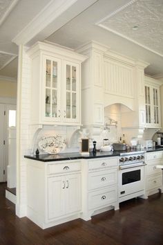 a kitchen with white cabinets and black counter tops is featured in the color palettes