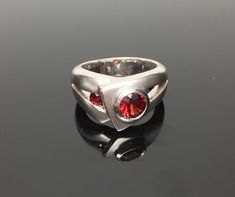 "Hi everyone, just wanted to let you know we are open and shipping daily. Silver Garnet Ring // Matte Platinum (Rhodium) Finish // Handmade // Modern Design // Size 7 Beautifully crafted \"one of a kind\" contemporary Sterling Silver ring with genuine Garnet center stone. This garnet is of a deep ruby red color. The silver ring is finished with Rhodium so it will not tarnish. This fine jewelry quality ring is perfect for work and formal occasions to match your sterling, white gold or platinum je Silver Garnet Ring, Ruby Red Color, Garnet Ring Silver, Clover Ring, Platinum Jewelry, Blue Topaz Earrings, Garnet Ring, Handmade Modern, Topaz Earrings