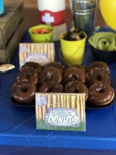 chocolate donuts are sitting on a blue table